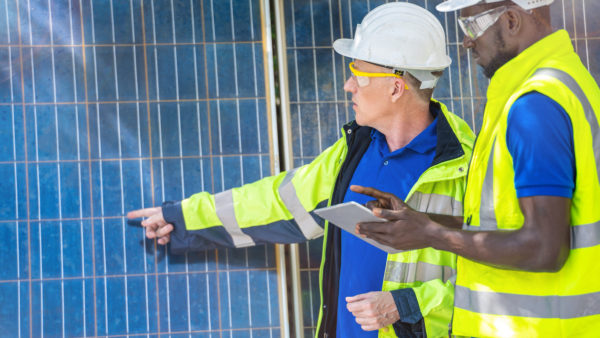 Factory worker technician engineer men showing and checking solar cell panel. Image: Dreamstime