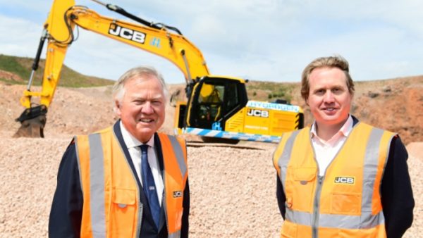 Lord Bamford and Jo Bamford in front of JCB's hydrogen-powered prototype
