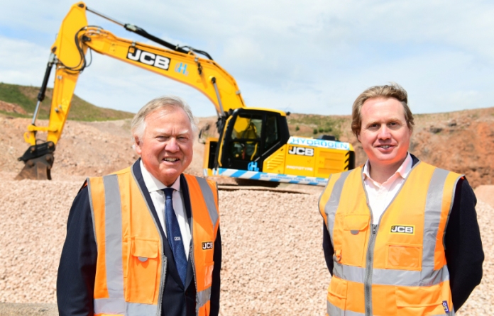 Construction rich list - Lord Bamford and Jo Bamford in front of JCB's hydrogen-powered prototype