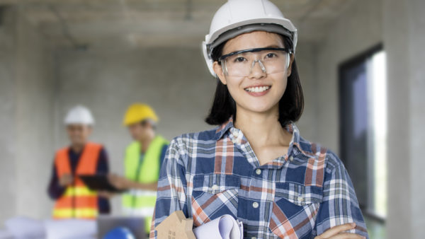 Asian woman on construction site. Image: Dreamstime