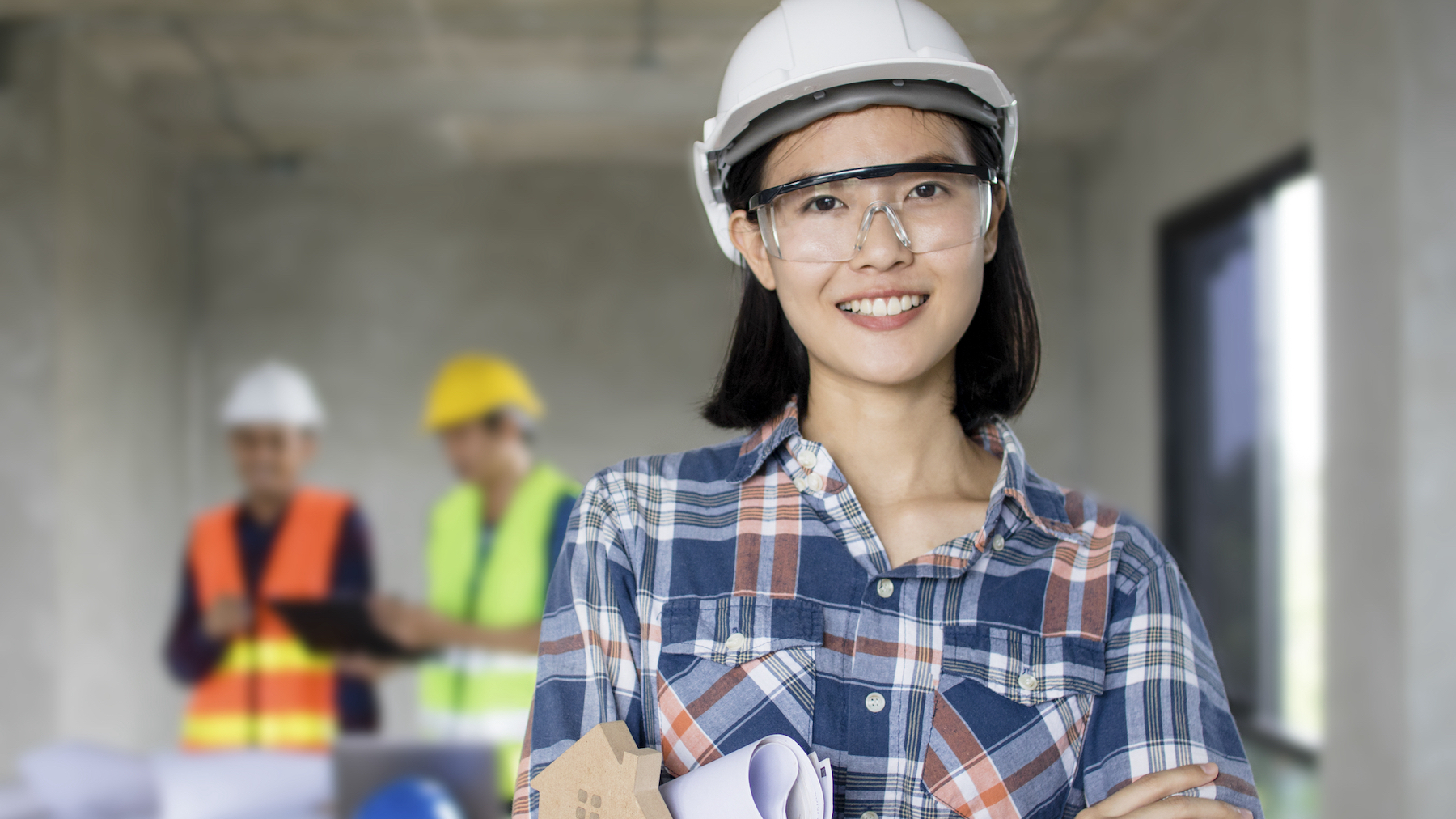 Asian woman on construction site. Image: Dreamstime