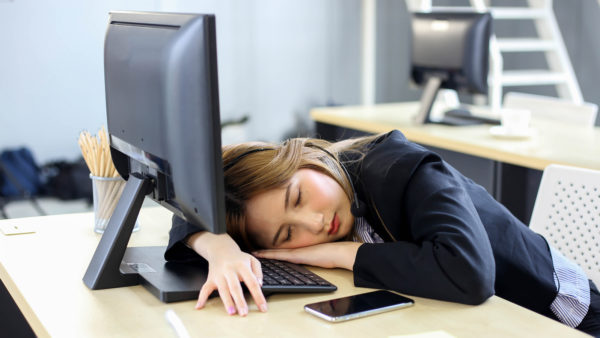 Woman fallen asleep at computer. Image: Dreamstime