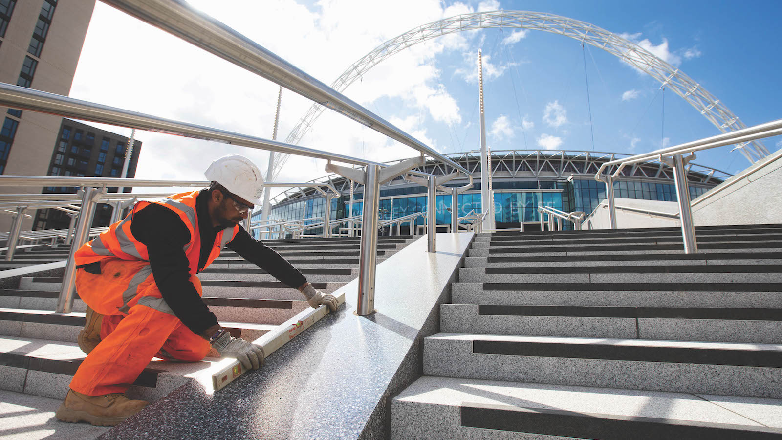 Construction workers make finishing touches to the newly installed Olympic Steps at Wembley Park in London, as part of an area-wide upgrade to the Wembley Park destination. Photo credit: David Parry/PA Wire