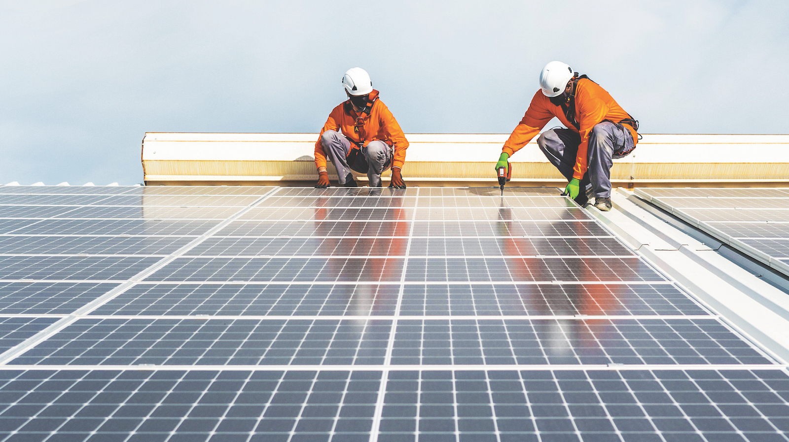 Unrecognizable solar panel technicians working a Spanish factory