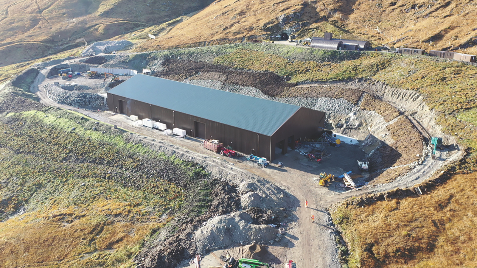 The processing building is cut into the mountainside