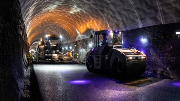 Super-smooth tarmac being laid by machines inside the Victorian railway tunnel