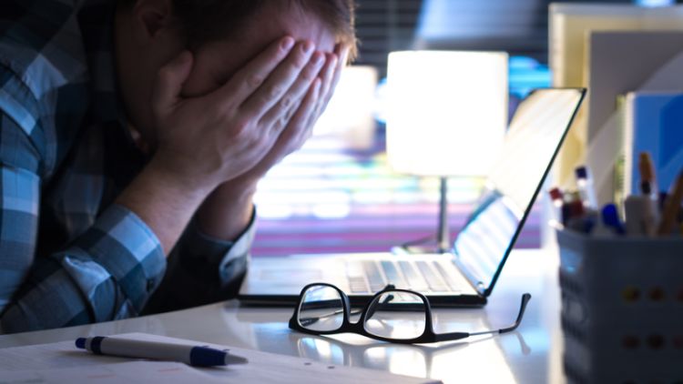 Man experience stress at his laptop