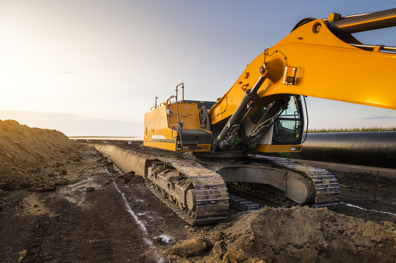 An excavator digs next to a pipeline (Image: Dreamstime)