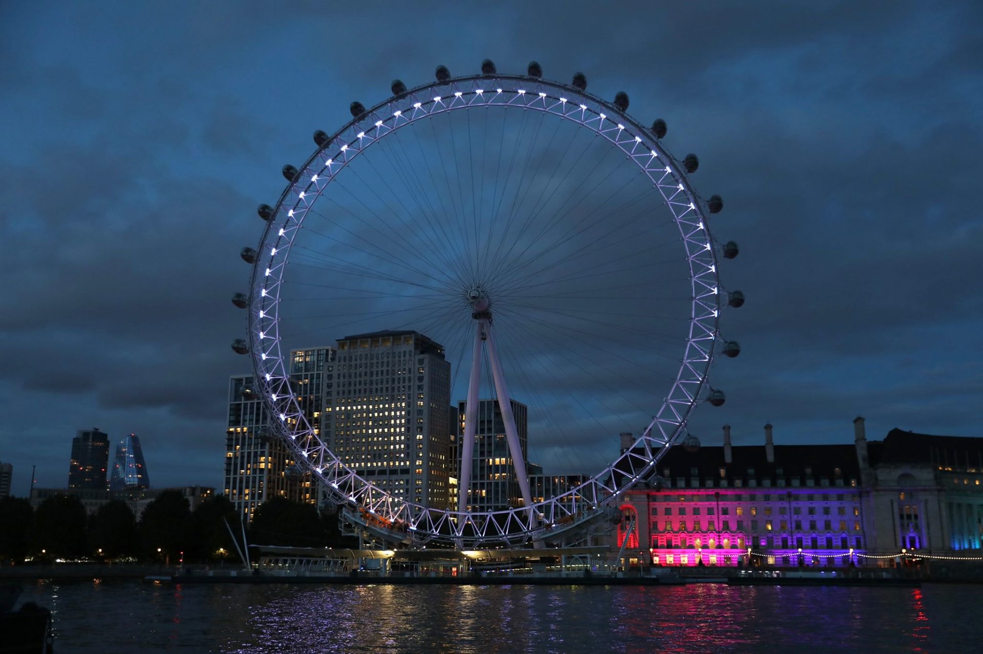 London landmarks across the capital, including the London Eye, have been lit up purple to mark the Elizabeth Line's opening