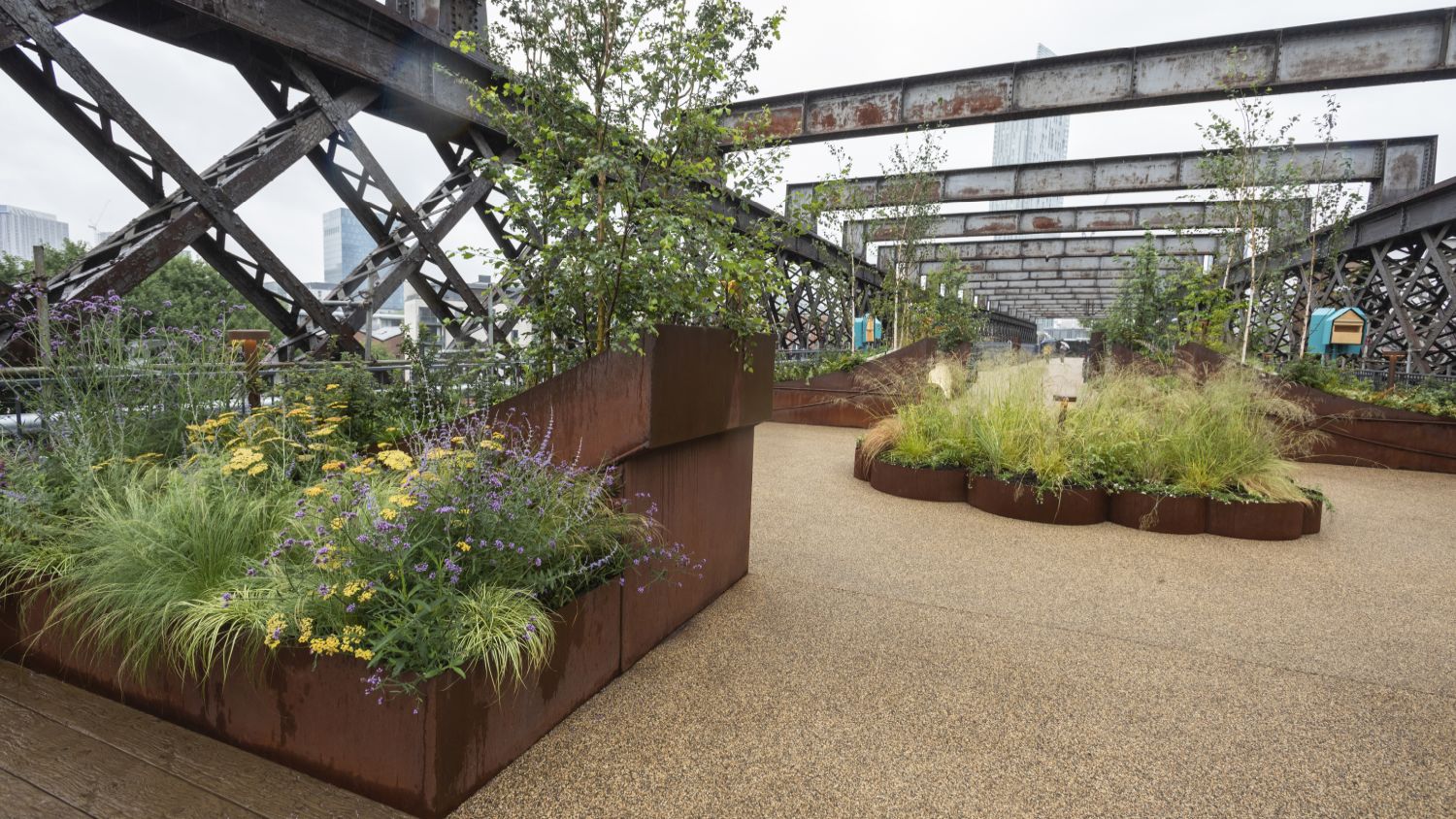 Industrial planters full of new plants sit on the transformed Castlefield Viaduct in Manchester, as part of a new urban 'sky park'.