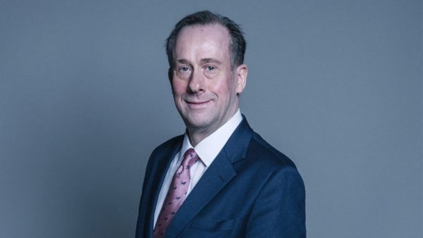 Portrait of Lord Callanan in a blue suit wearing a light purple tie