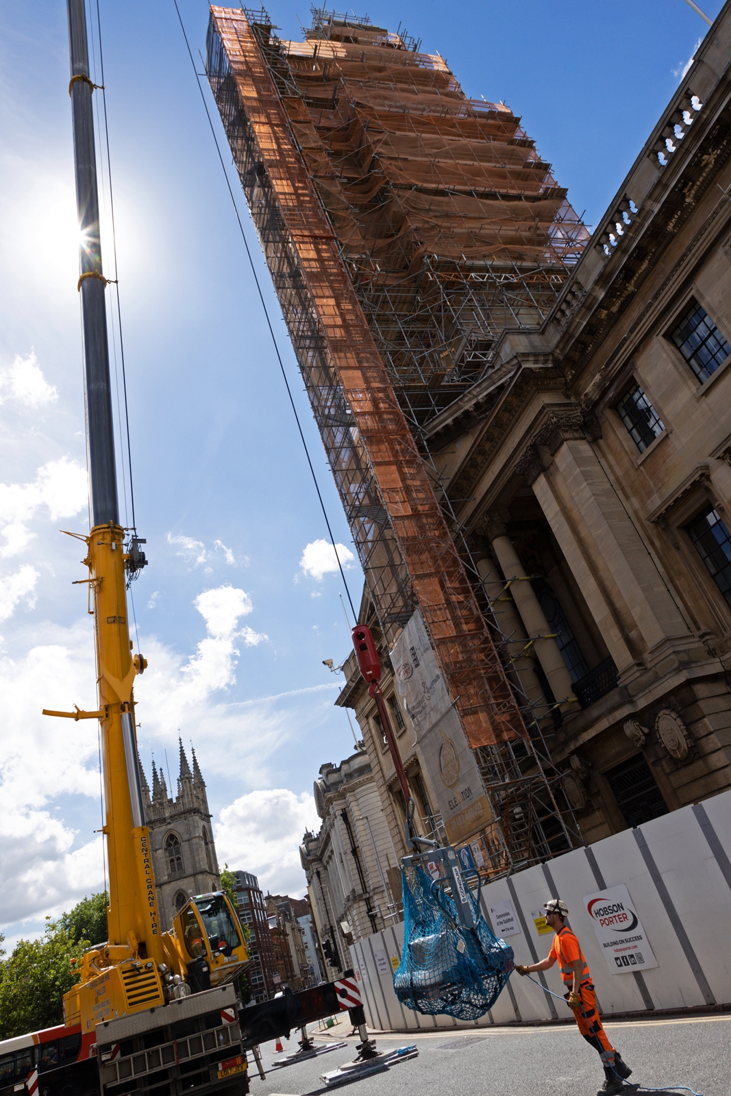 A crane lifts the stone putties 70m into the air at Hull's Guildhall