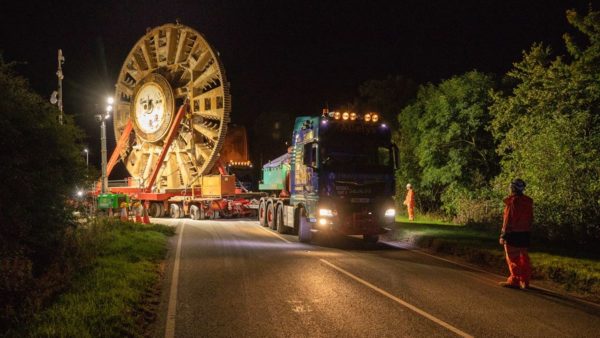 The HS2 cutterhead leaves the south portal site. It sits vertically on a low loader towed by a lorry. (Image: HS2)