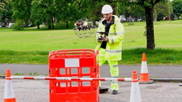 A drone operator lowers a drone into a sewer (Image: Scottish Water)