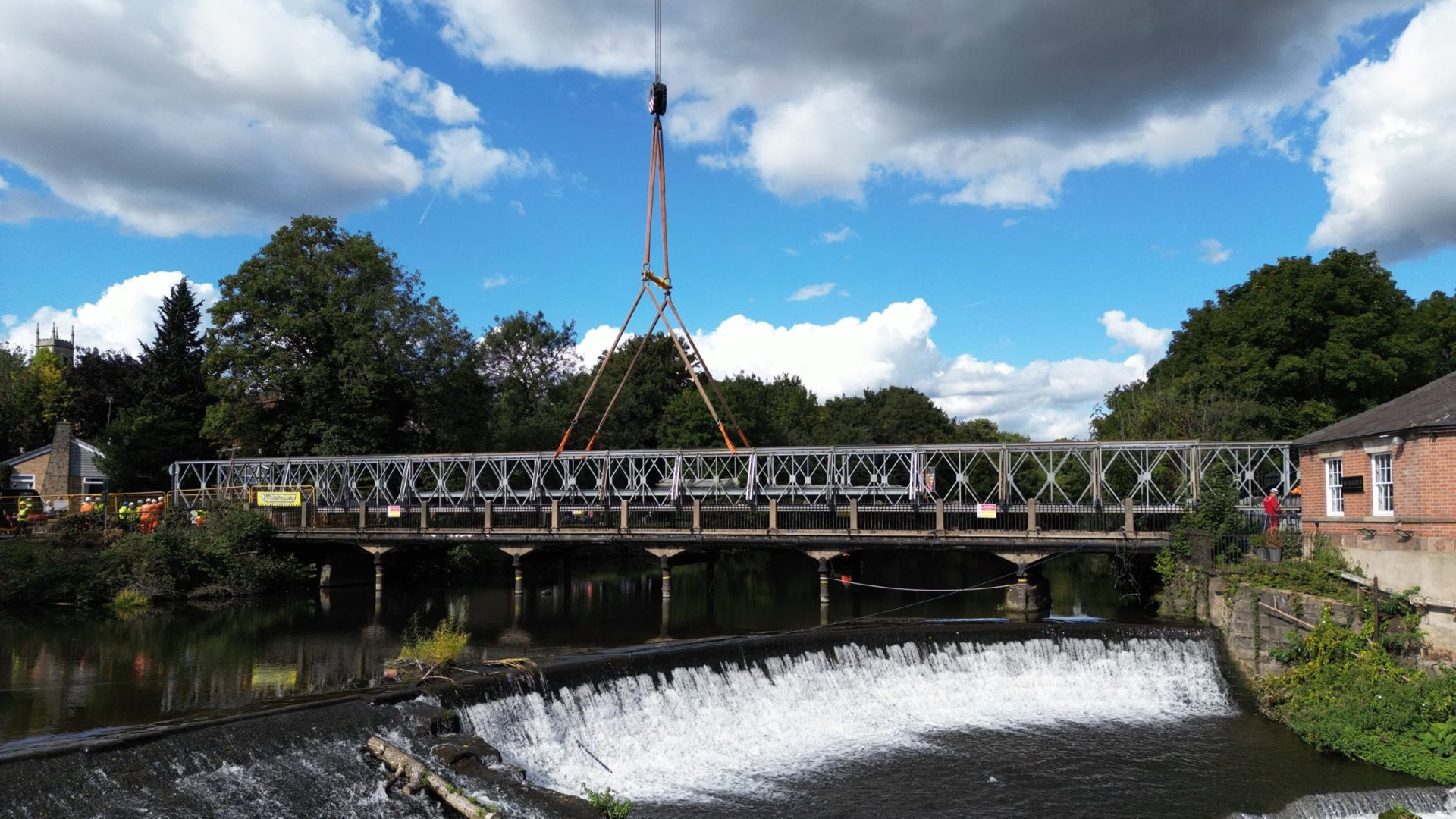 A 500-tonne capacity crane lifts a temporary bridge into position