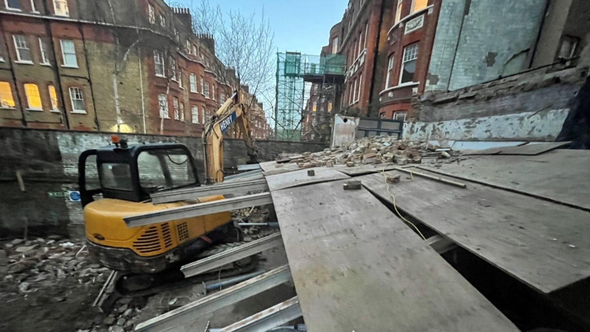 fall from height - A construction site with rubble and a digger.