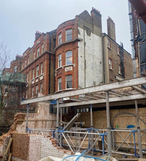 fall from height - A construction site with red brick houses at the back.