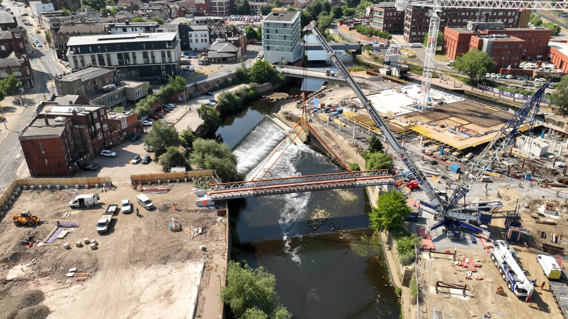 Forge Island bridge Aerial view of a bridge being lifted in place.