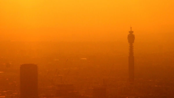 Aerial view of London covered in orange smog.