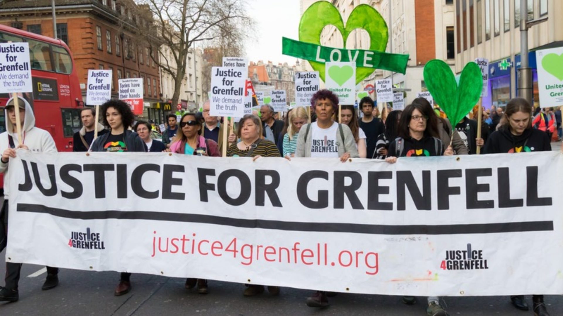 Rydon Grenfell - A group of people marching behind a banner that says 'Justice for Grenfell'