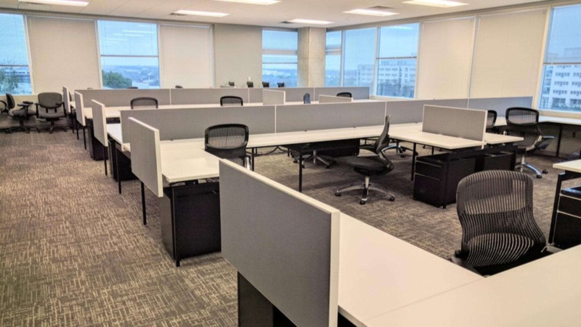 An empty office, there are only desks and chairs.