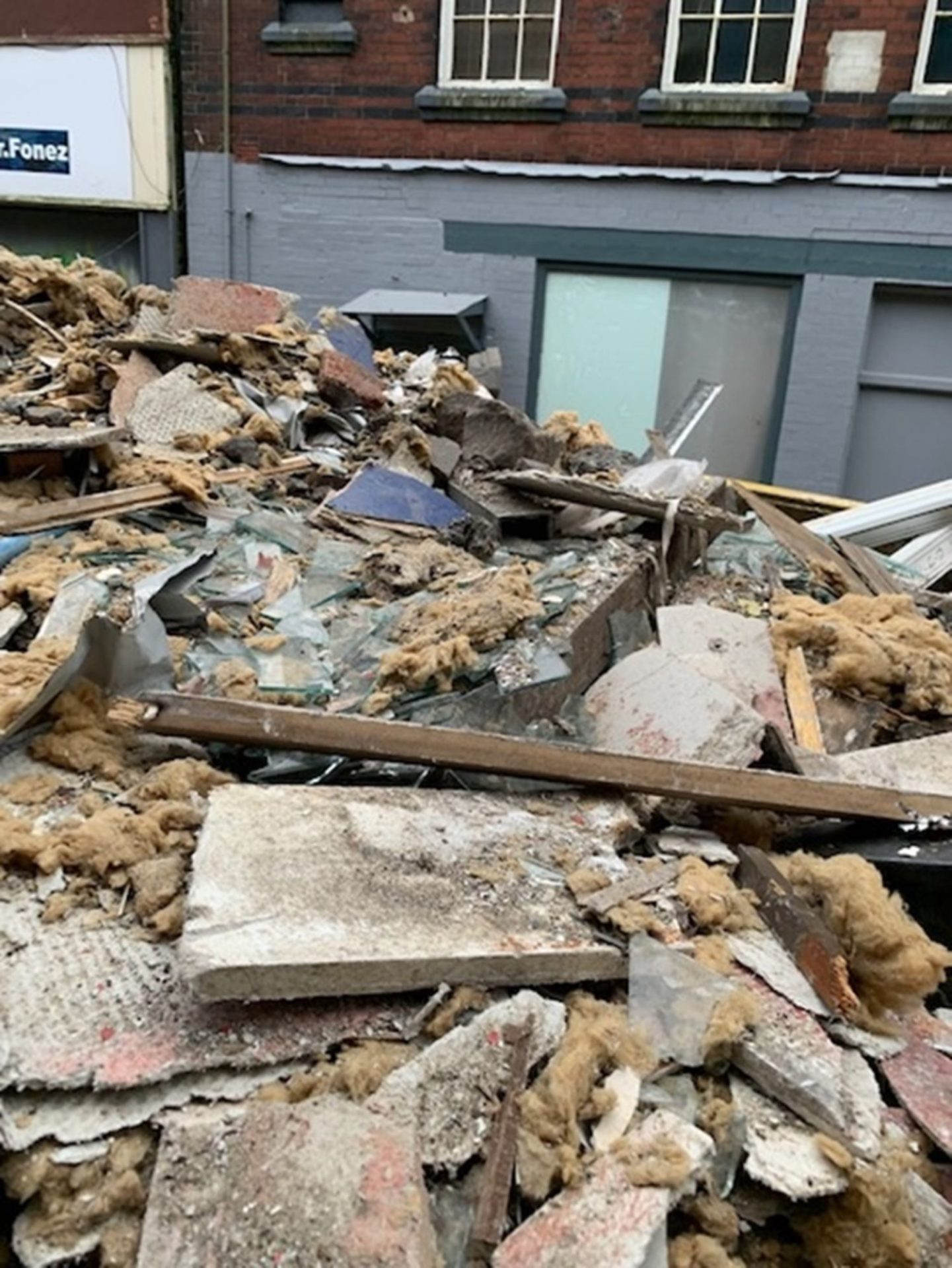 Significant amounts of asbestos-containing debris to the front and rear of the building and along the public highway (image: HSE).