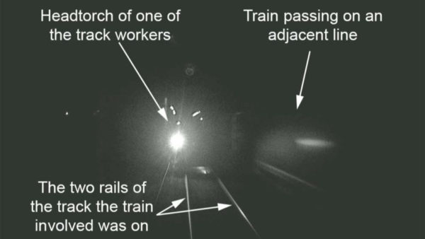 An image of CCTV showing a train head in the dark.