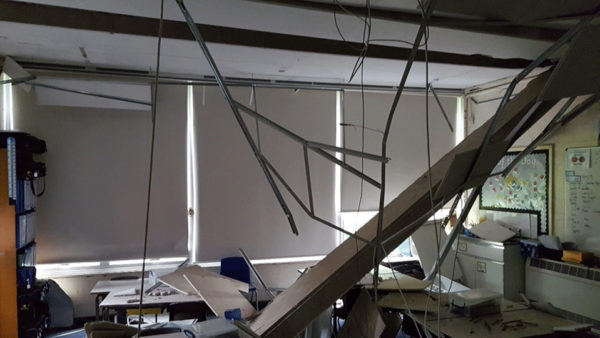 A classroom where the ceiling has collapsed.