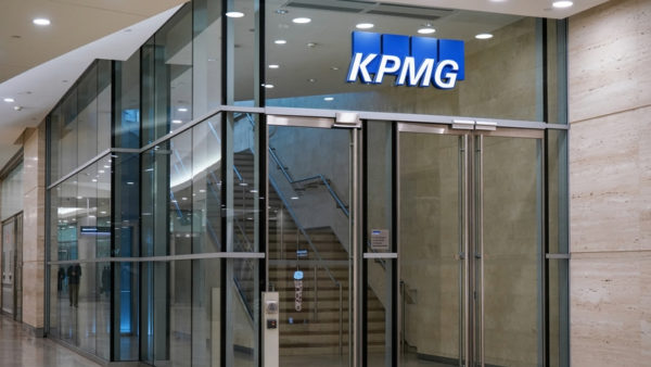 Entrance to an office building with the logo KPMG.