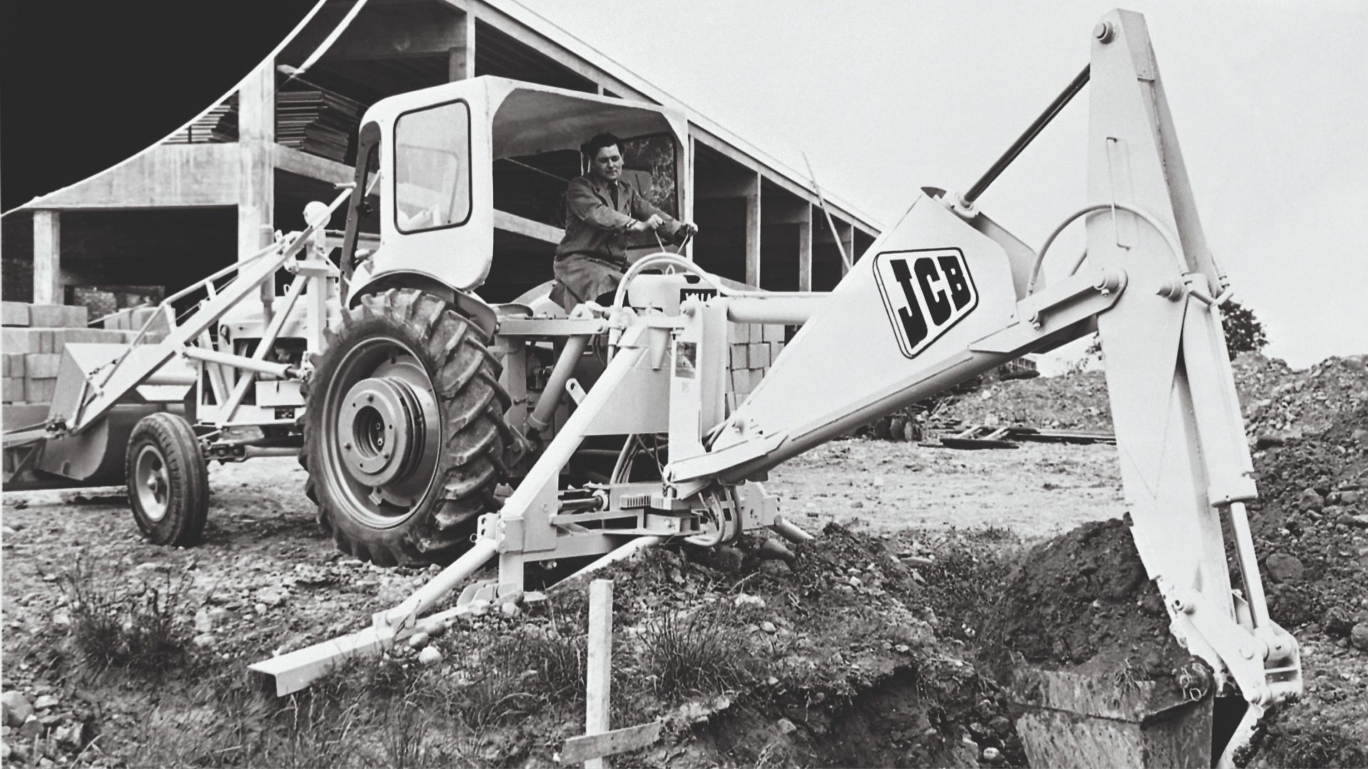 Black and white picture of a man in an excavator.