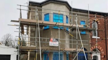 A house with scaffolding outside.