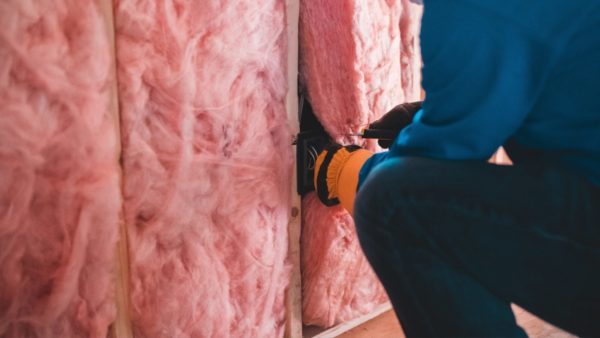 Worker installing cavity wall insulation