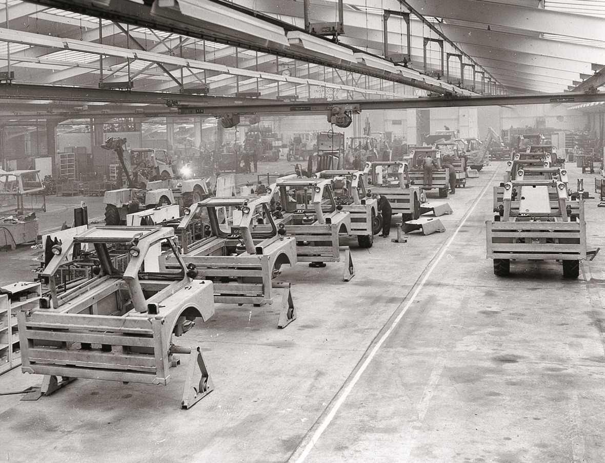 A black and white photo of an excavator production line.