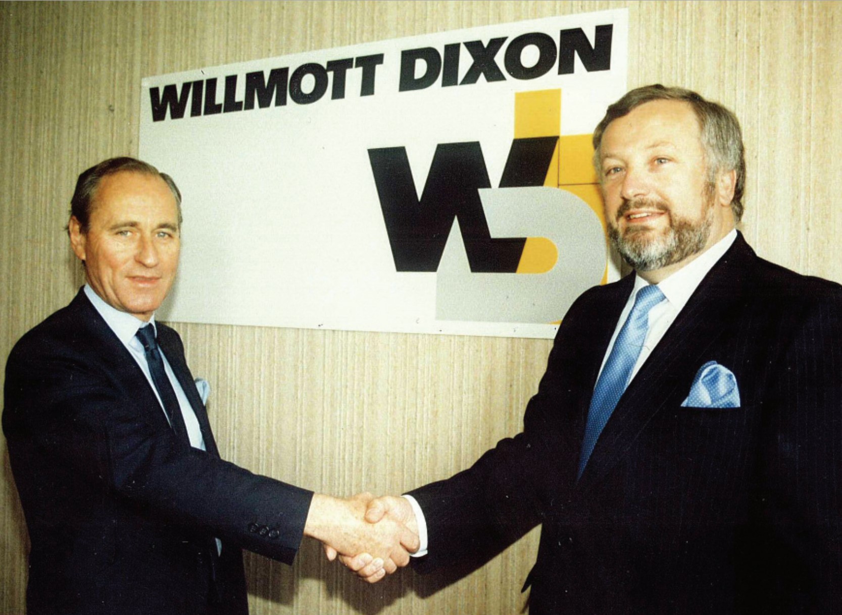 Peter Willmott and Sir Ian Dixon shake hands on the creation of the
Willmott Dixon name.