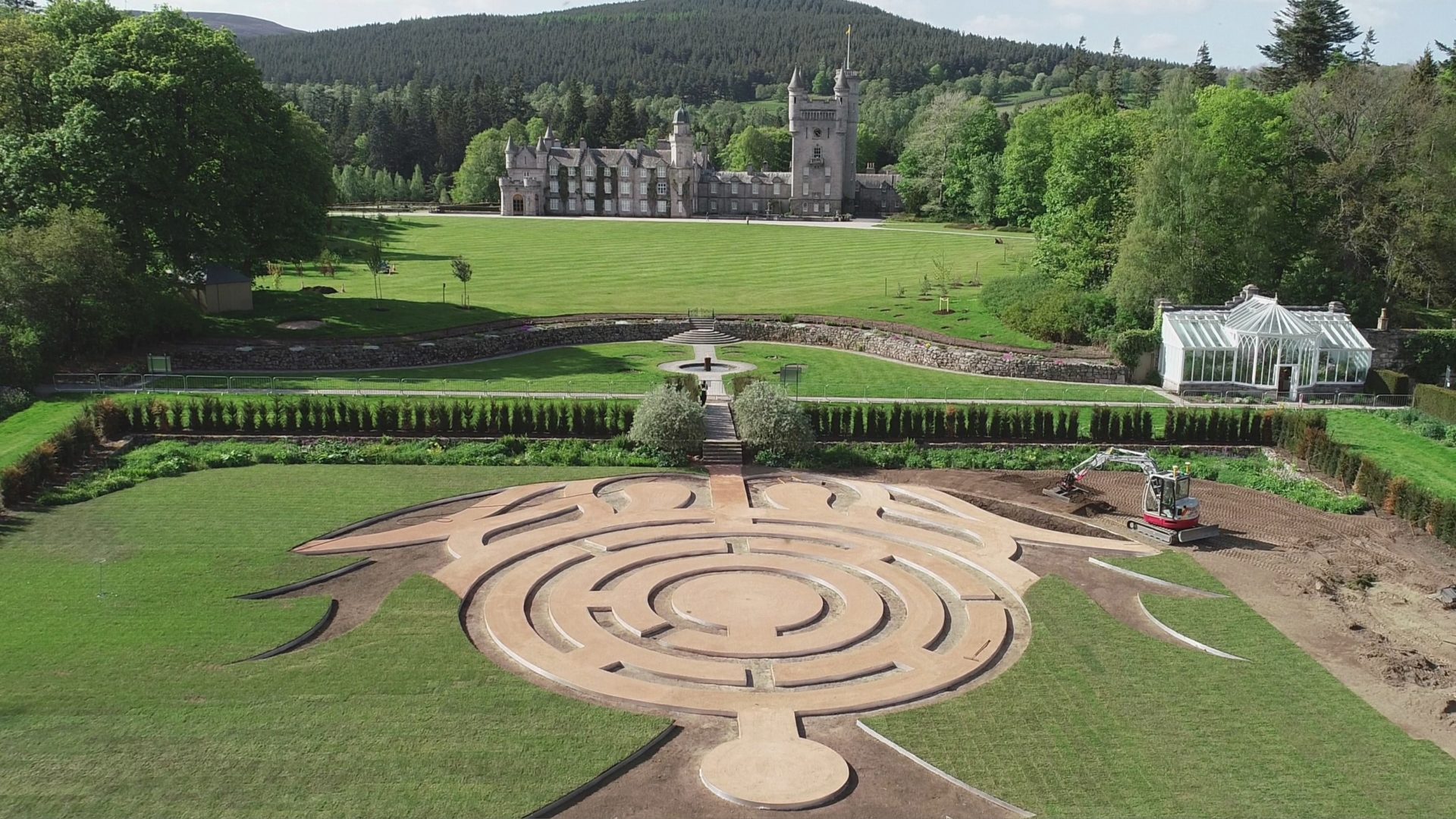 Aerial view of a maze and a castle in the background.