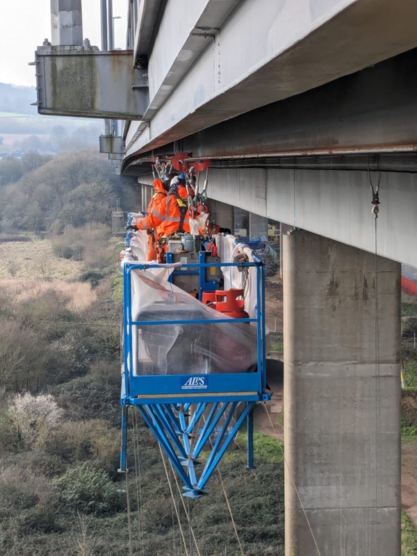 Inspection work taking place on a runway beam under the bridge parapets of Avonmouth Bridge