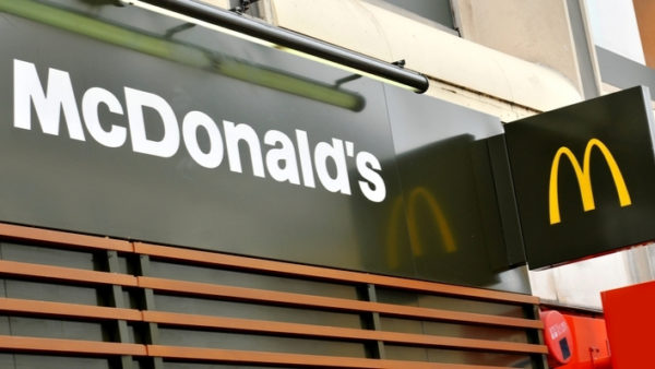 Green front of a McDonald's restaurant with the yellow 'M' logo