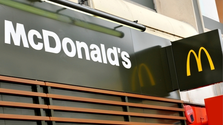 Green front of a McDonald's restaurant with the yellow 'M' logo