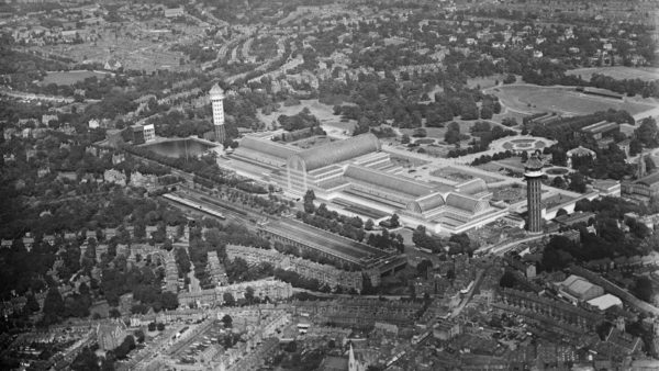 The original Crystal Palace in the 1930s, prior to the fire, with the old High Level station in the foreground (image: Historic England).