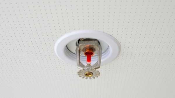 Automatic fire sprinkler installed on a ceiling.