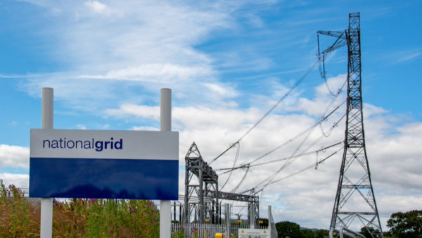 National Grid substation with electricity pylons next to a sign.