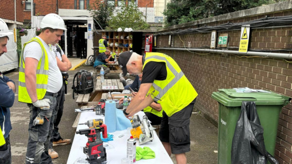 Workers in high-vis jackets trialling the forensic marking technology at a McAlpine site.