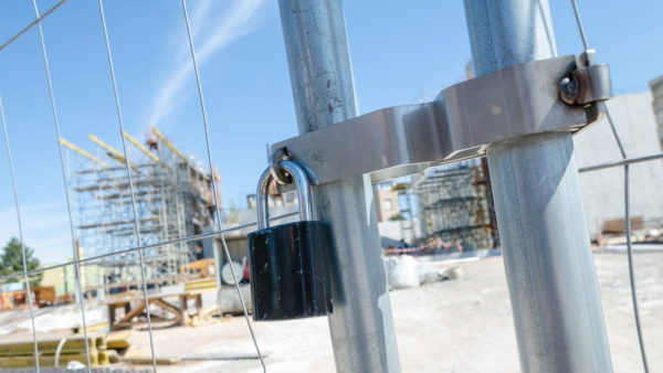 Padlock on a gate of a construction site.