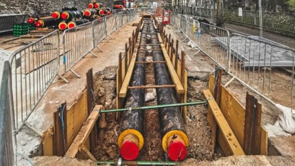 Two big pipes in a construction site - the government has announced the trial of six heat networks across England.