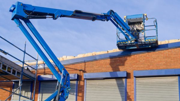 Access platform equipment powered high in sky at construction building site UK - IPAF and the HSE have issued new guidance on the safe methods of isolation of platform controls for mobile elevating work platforms