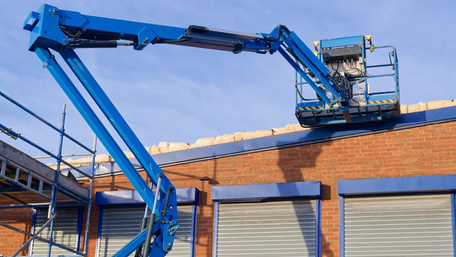 MEWPs - Access platform equipment powered high in sky at construction building site UK - IPAF and the HSE have issued new guidance on the safe methods of isolation of platform controls for mobile elevating work platforms