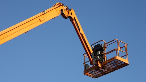 The arm and platform of a yellow cherry picker - a construction firm in Glasgow has been fined after a worker suffered serious injuries following a fall from a cherry picker.