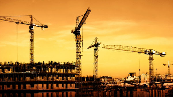 A large construction site with sunset on the background