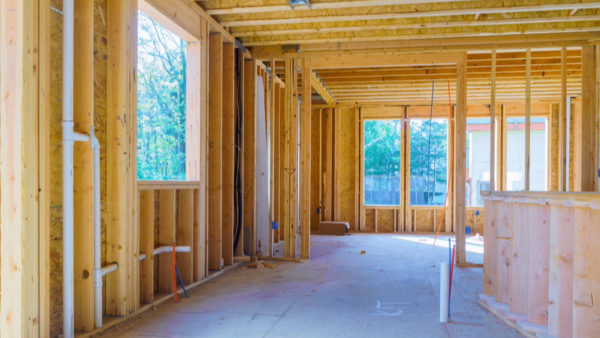 Inside of a house being built with timber frames. Bellway is opening a new timber frame production facility, ‘Bellway Home Space’, with the first homes expected to be produced in mid-2026