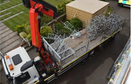 The lorry mounted crane used to lift the temporary mast climber work platform - a company has been fined £1.6m following the death of ‘happy-go-lucky’ 24-year-old worker